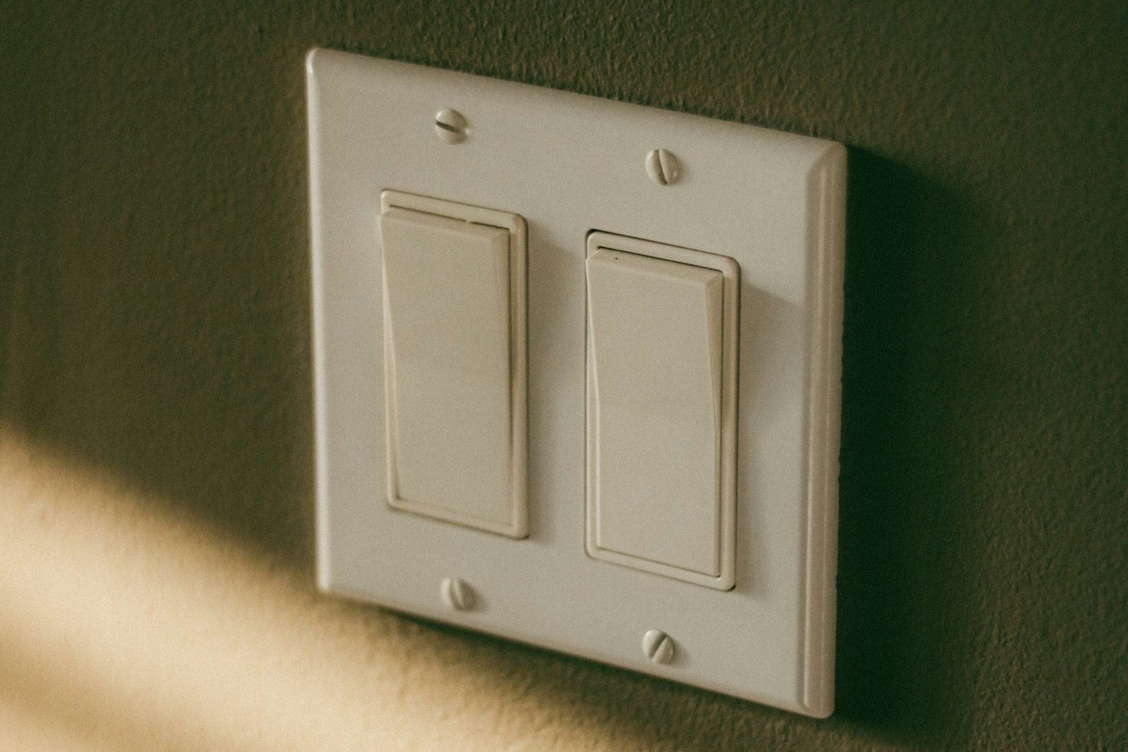 Lichtschalter mit leicht schief sitzender Wippe in einem weißen Rahmen